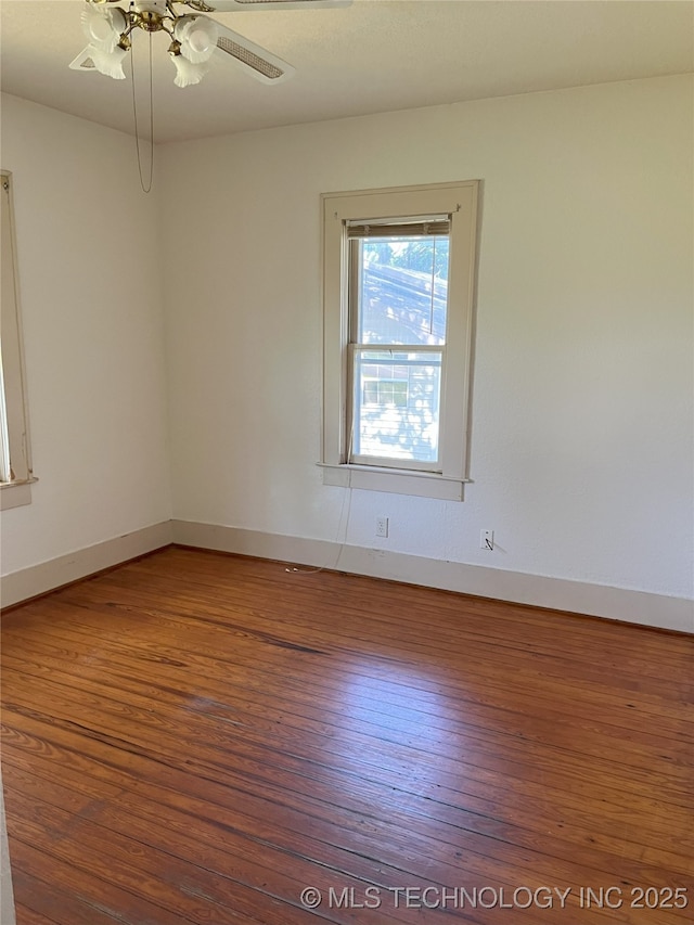701 NW 3rd St, Stigler, OK 74462 - empty room featuring wood finished floors and baseboards