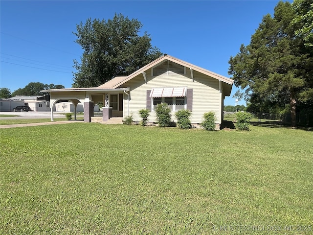 701 NW 3rd St, Stigler, OK 74462 - ranch-style home with a front yard and a carport