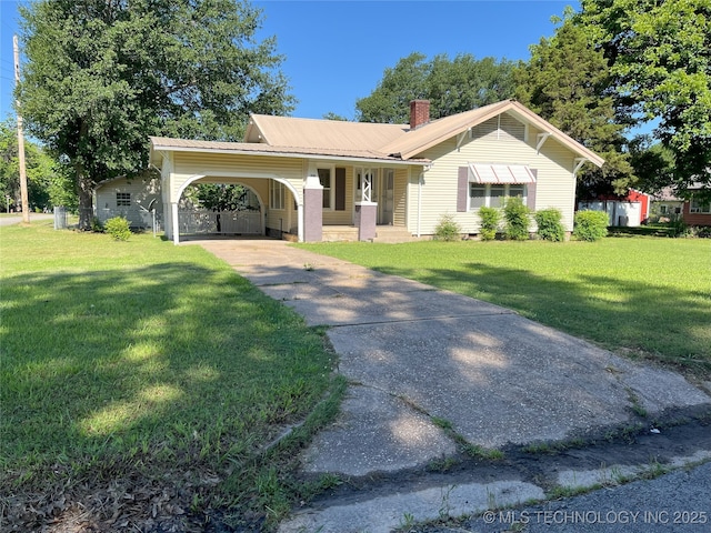 701 NW 3rd St, Stigler, OK 74462 - ranch-style house featuring concrete driveway, a front yard, a chimney, and metal roof