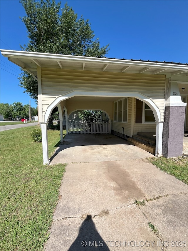 701 NW 3rd St, Stigler, OK 74462 - view of parking with concrete driveway and a carport