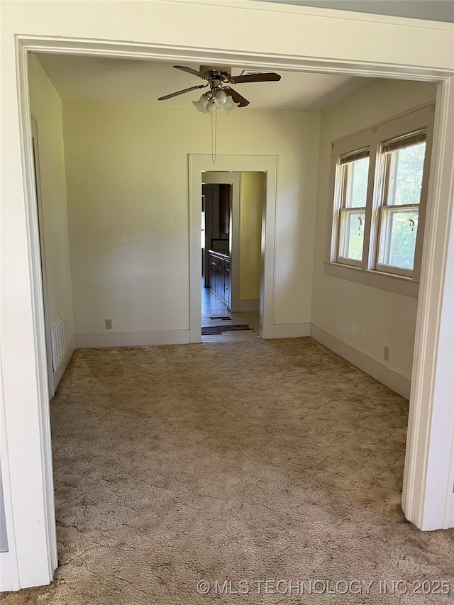 701 NW 3rd St, Stigler, OK 74462 - carpeted empty room with ceiling fan and baseboards