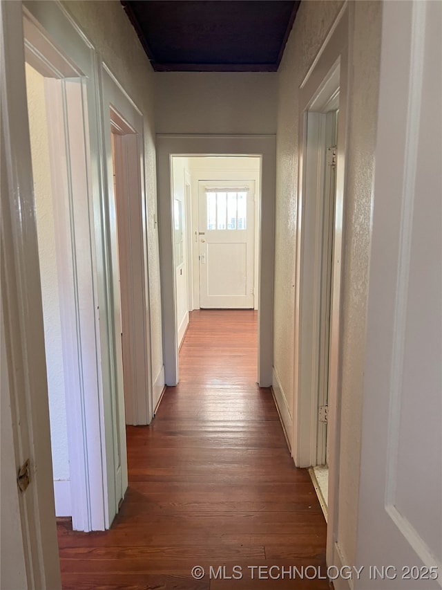 701 NW 3rd St, Stigler, OK 74462 - hall with dark wood finished floors and a textured wall