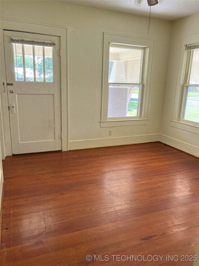 701 NW 3rd St, Stigler, OK 74462 - entryway with wood finished floors, baseboards, and ceiling fan