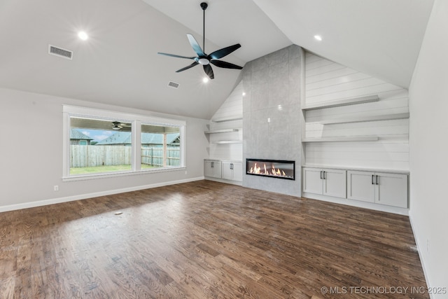 23250 E 106th Pl S, Broken Arrow, OK 74014 - unfurnished living room with a ceiling fan, high vaulted ceiling, wood finished floors, a large fireplace, and baseboards