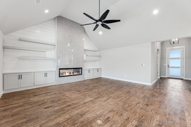 23250 E 106th Pl S, Broken Arrow, OK 74014 - unfurnished living room with vaulted ceiling, wood finished floors, a ceiling fan, baseboards, and a large fireplace