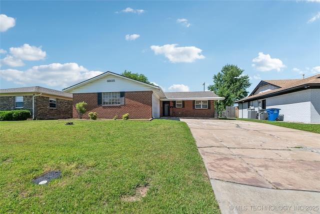 8805 E 46th Pl, Tulsa, OK 74145 - single story home featuring concrete driveway and brick siding