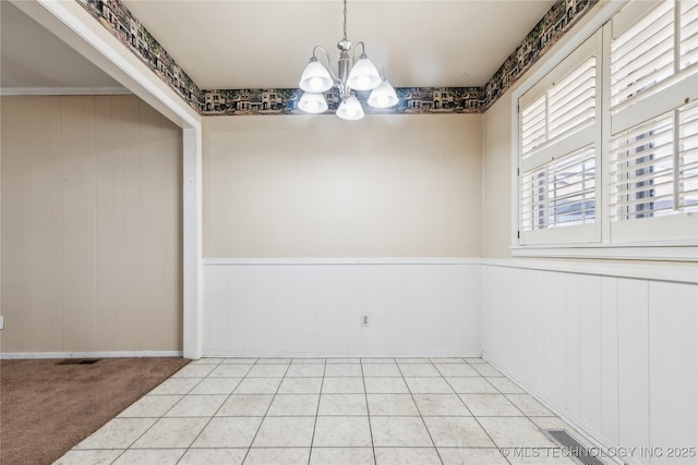 8805 E 46th Pl, Tulsa, OK 74145 - unfurnished room featuring a chandelier and a wainscoted wall