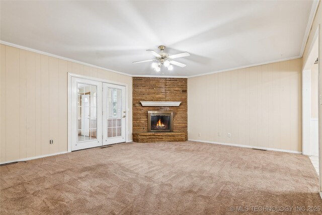 8805 E 46th Pl, Tulsa, OK 74145 - unfurnished living room with a ceiling fan, crown molding, a fireplace, carpet, and wood walls