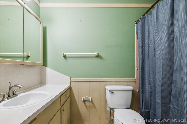 8805 E 46th Pl, Tulsa, OK 74145 - bathroom featuring a wainscoted wall, vanity, toilet, and a shower with curtain