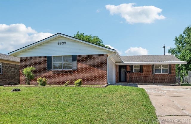8805 E 46th Pl, Tulsa, OK 74145 - ranch-style house with a front yard, brick siding, and driveway