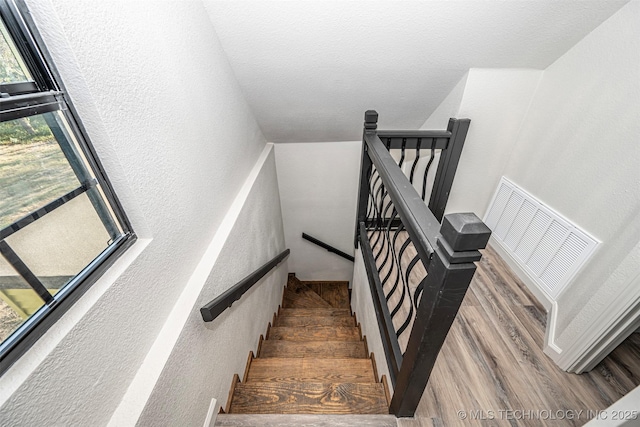 731 8th Ave NW, Ardmore, OK 73401 - stairway with a textured wall and wood finished floors
