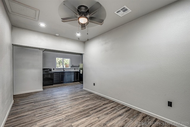 731 8th Ave NW, Ardmore, OK 73401 - spare room featuring baseboards, ceiling fan, dark wood-style floors, and recessed lighting