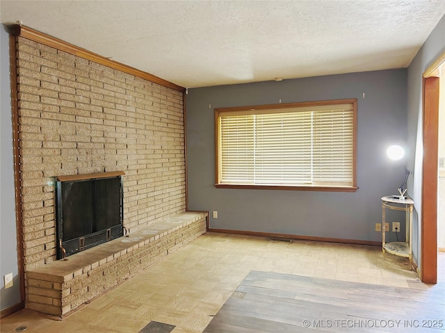 303 W Mckinley Ave, Sapulpa, OK 74066 - unfurnished living room with a textured ceiling, baseboards, and a brick fireplace