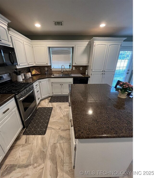 19416 E 38th St S, Broken Arrow, OK 74014 - kitchen with gas range, black microwave, a sink, tasteful backsplash, and white cabinets