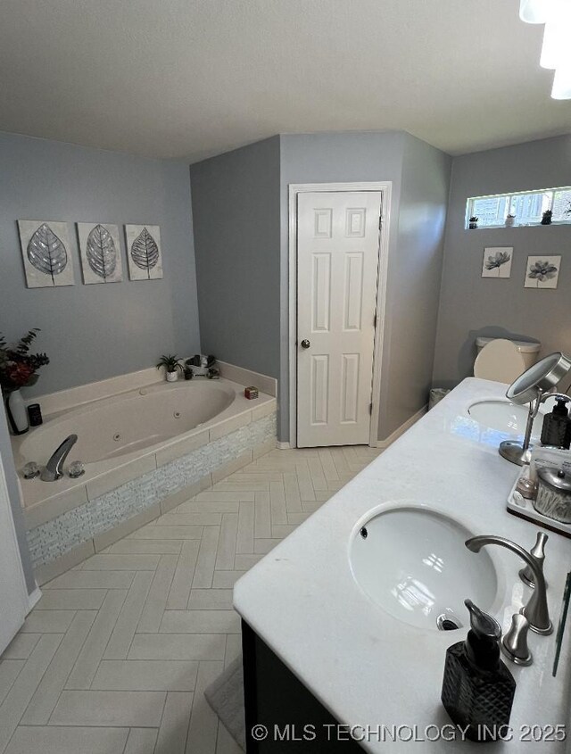 19416 E 38th St S, Broken Arrow, OK 74014 - bathroom with double vanity, a jetted tub, and tile patterned flooring