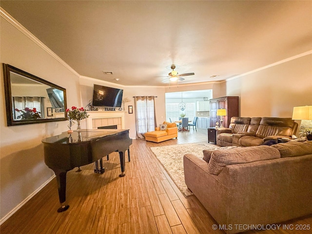 27434 E 113th St, Coweta, OK 74429 - living area with a ceiling fan, ornamental molding, wood finished floors, a tile fireplace, and baseboards