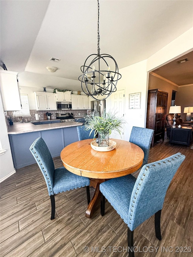 27434 E 113th St, Coweta, OK 74429 - dining space with dark wood-style floors and a chandelier