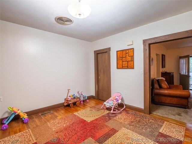 611 N Hickory, Mcalester, OK 74501 - rec room with baseboards and wood finished floors