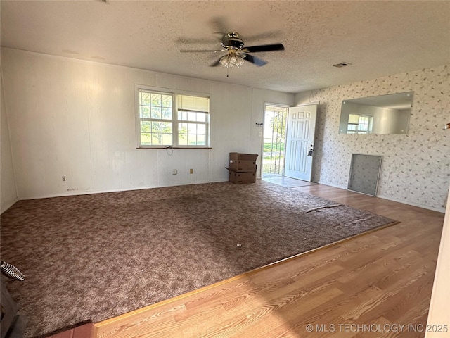 621 S 3rd St, Morris, OK 74445 - unfurnished living room featuring ceiling fan, wood finished floors, and a textured ceiling
