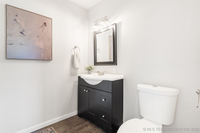 9110 E 37th Ct, Tulsa, OK 74145 - half bath with wood finished floors, baseboards, toilet, and vanity