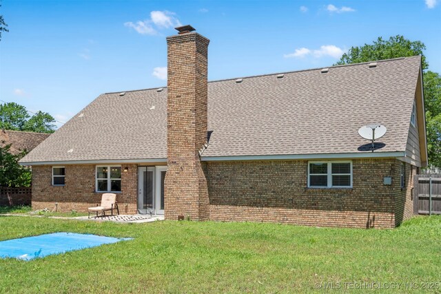 9110 E 37th Ct, Tulsa, OK 74145 - back of house featuring a chimney, brick siding, a shingled roof, and a patio area