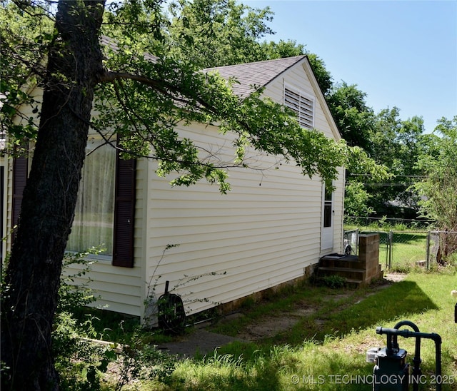 805 W Cummings St, Henryetta, OK 74437 - view of side of property with a shingled roof