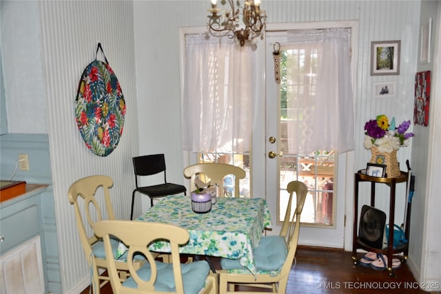 805 W Cummings St, Henryetta, OK 74437 - dining space with a chandelier, wood finished floors, french doors, and wallpapered walls