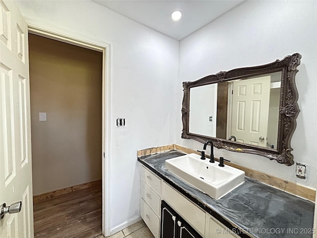 1107 SE 5th St, Wagoner, OK 74467 - bathroom with vanity, wood finished floors, and baseboards