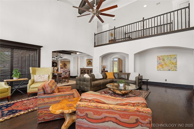 3511 E 181st St S, Bixby, OK 74008 - living area with arched walkways, a ceiling fan, a towering ceiling, wood finished floors, and a chandelier