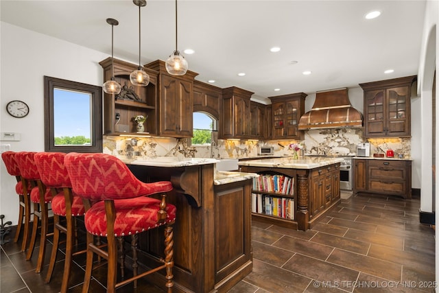 3511 E 181st St S, Bixby, OK 74008 - kitchen featuring open shelves, premium range hood, dark brown cabinetry, decorative backsplash, and recessed lighting