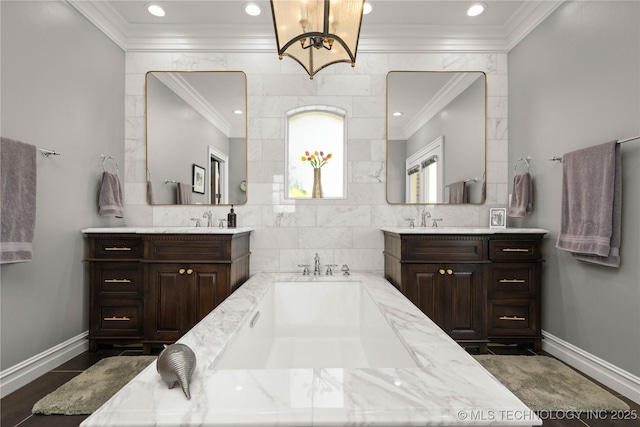 3511 E 181st St S, Bixby, OK 74008 - bathroom featuring ornamental molding, two vanities, a bath, a chandelier, and recessed lighting