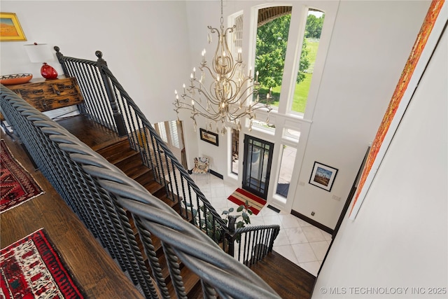 3511 E 181st St S, Bixby, OK 74008 - foyer entrance with a chandelier, a towering ceiling, light tile patterned floors, and baseboards