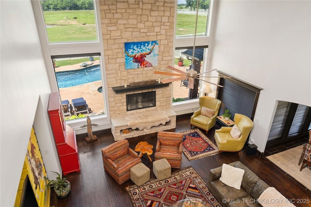 3511 E 181st St S, Bixby, OK 74008 - living room with wood finished floors, a stone fireplace, and a high ceiling