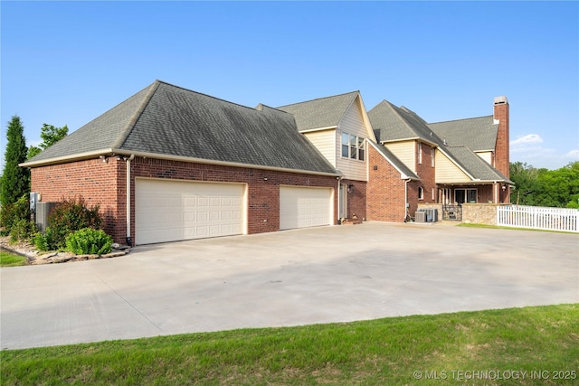 3511 E 181st St S, Bixby, OK 74008 - view of front of house with brick siding, an attached garage, concrete driveway, and a chimney