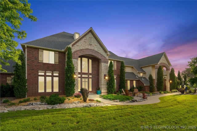 3511 E 181st St S, Bixby, OK 74008 - view of front of home with brick siding, stone siding, a front lawn, and a shingled roof