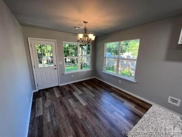 130 W Lincoln Ave, Sapulpa, OK 74066 - unfurnished dining area with a chandelier, dark wood-style floors, and baseboards