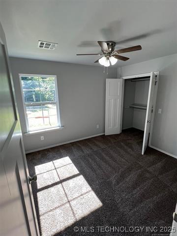 130 W Lincoln Ave, Sapulpa, OK 74066 - unfurnished bedroom with carpet floors, a closet, ceiling fan, and baseboards