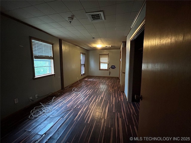 722 S Pine St, Nowata, OK 74048 - empty room featuring plenty of natural light and wood finished floors