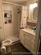 596 Forest Ln, Durant, OK 74701 - bathroom with a shower stall, toilet, and vanity