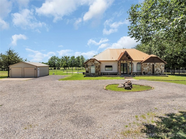 26115 US Highway 70, Bokchito, OK 74726 - view of front of house featuring stone siding, a garage, an outbuilding, and metal roof