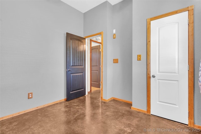 26115 US Highway 70, Bokchito, OK 74726 - unfurnished bedroom featuring finished concrete floors and baseboards