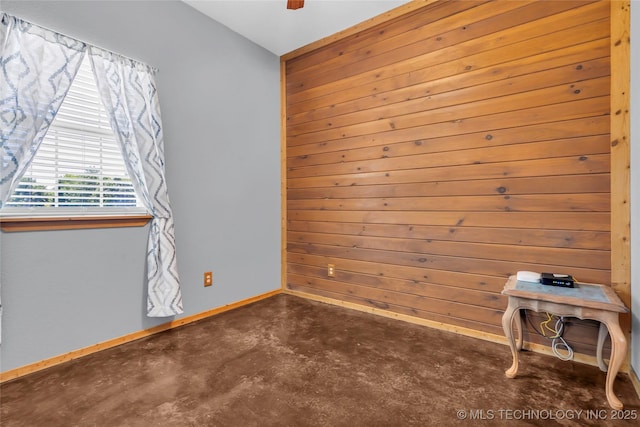 26115 US Highway 70, Bokchito, OK 74726 - spare room featuring concrete flooring, baseboards, wood walls, and vaulted ceiling