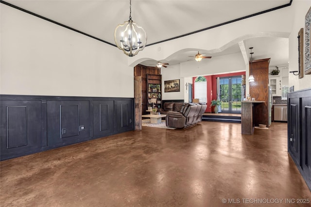 26115 US Highway 70, Bokchito, OK 74726 - dining room with arched walkways, a ceiling fan, finished concrete flooring, a chandelier, and wainscoting