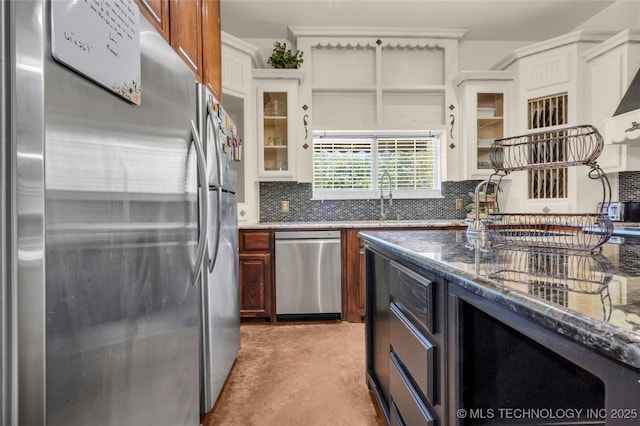 26115 US Highway 70, Bokchito, OK 74726 - kitchen featuring stainless steel appliances, a sink, decorative backsplash, glass insert cabinets, and dark stone countertops