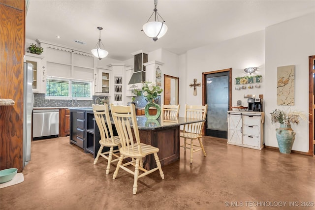 26115 US Highway 70, Bokchito, OK 74726 - kitchen featuring appliances with stainless steel finishes, finished concrete flooring, a kitchen bar, and a center island