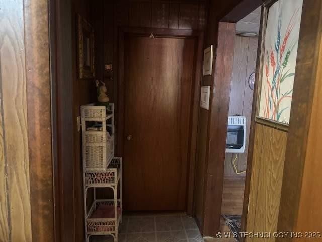 223 W Delaware St, Jay, OK 74346 - corridor with tile patterned flooring, heating unit, and wood walls