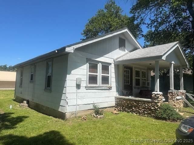 223 W Delaware St, Jay, OK 74346 - view of side of home featuring a yard