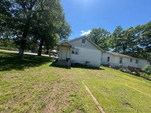 223 W Delaware St, Jay, OK 74346 - back of house featuring a yard
