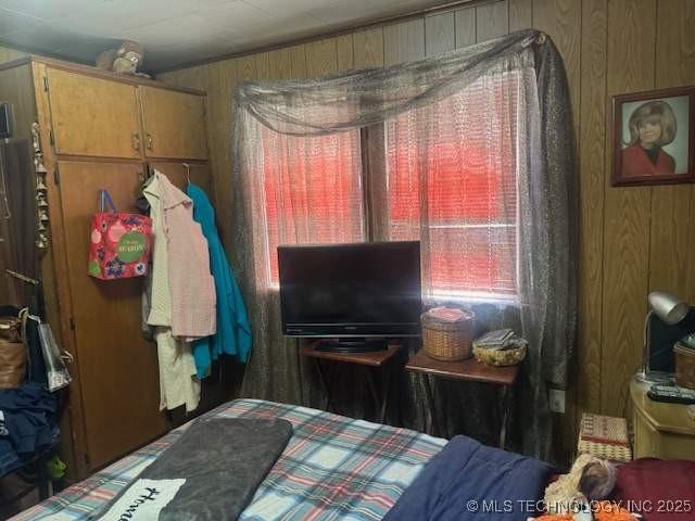 223 W Delaware St, Jay, OK 74346 - bedroom featuring wood walls