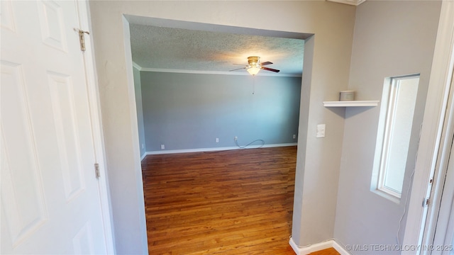 2205 E Foster Dr, Ada, OK 74820 - empty room with a ceiling fan, wood finished floors, a textured ceiling, ornamental molding, and baseboards